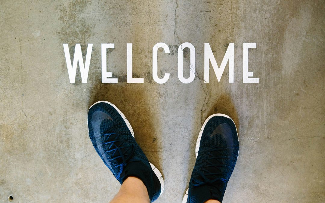 Welcome sign on the floor, representing the first step in helping newcomers feel comfortable joining a conversation group.
